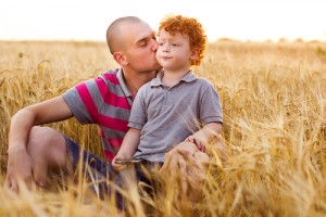 A man and boy in the middle of a field