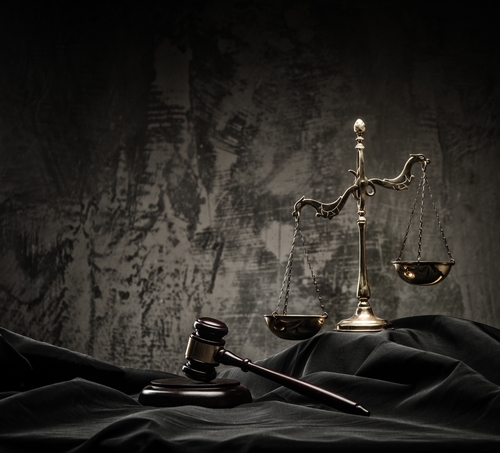 A judge 's gavel and scale on the table.