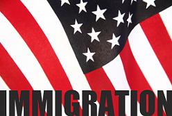 A close up of the word immigration on top of an american flag.