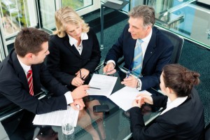 A group of people sitting around a table.