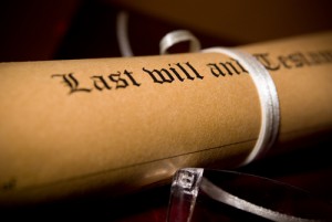 A roll of paper with the words " last will and testament ".